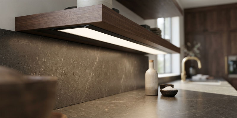Recessed LED strip lights mounted in extruded aluminum channels casting seamless under-cabinet counter illumination