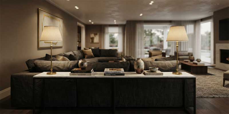 Pair of tall elegant living room lamps styled on a console table behind a floating sofa